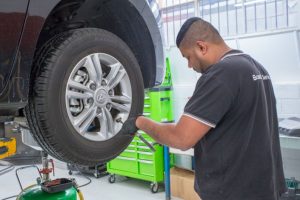 Mechanic working on tyres and wheel alignment